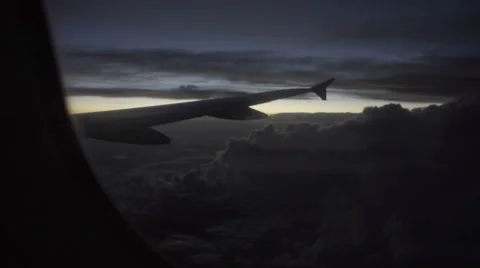Airplane flight at night - plane early evening flying after sunset dark clouds Stock Footage 67184006