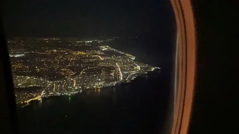 Airplane flight in the night sky over the glowing city lights. Stock Footage 236313071