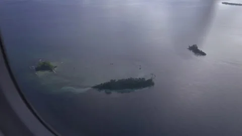Airplane flight over tiny islands in Solomons, Pacific Ocean Stock Footage 217366887