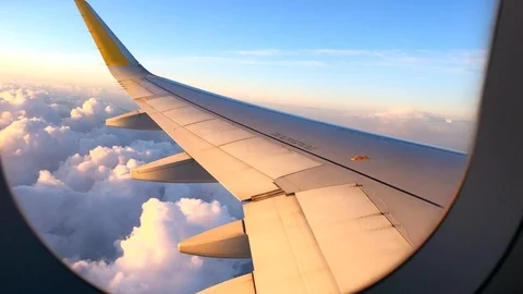 Airplane flight. Wing of an airplane flying above the clouds. View from the wind Stock Footage
