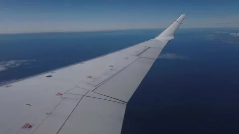 Airplane flight. Wing of an airplane flying above the ocean Stock Footage 134836735