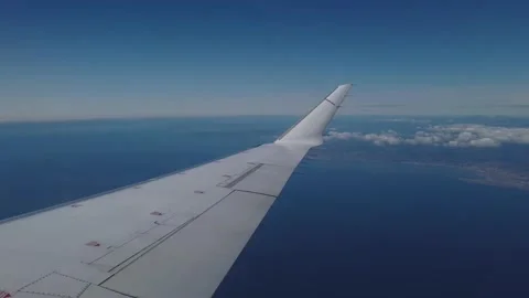Airplane flight. Wing of an airplane flying above the ocean Stock Footage 134836744