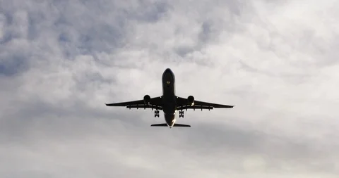 Airplane fly cross the cloudy sky Stock Footage 92557959