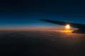 The airplane fly in a sky against the background of sunrise Photo