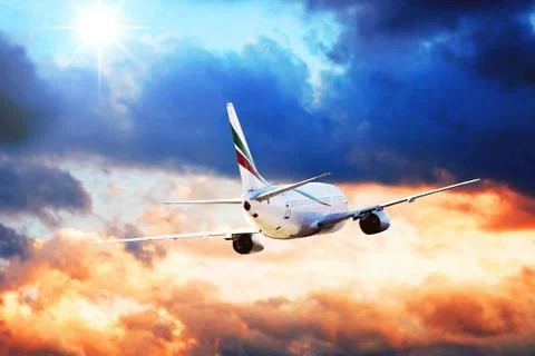 Airplane at fly on the sky with clouds Stock Photos
