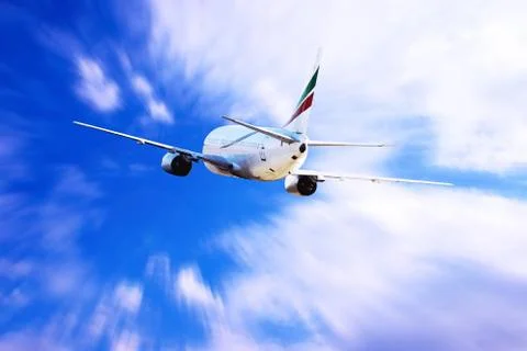 Airplane at fly on the sky with clouds Stock Photos
