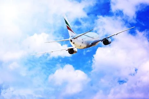 Airplane at fly on the sky with clouds Stock Photos