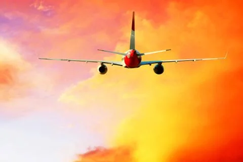 Airplane at fly on the sky with clouds Stock Photos