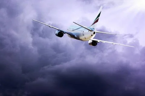 Airplane at fly on the sky with clouds Stock Photos