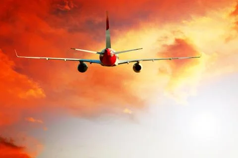 Airplane at fly on the sky with clouds Stock Photos