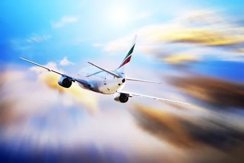 Airplane at fly on the sky with clouds Stock Photos