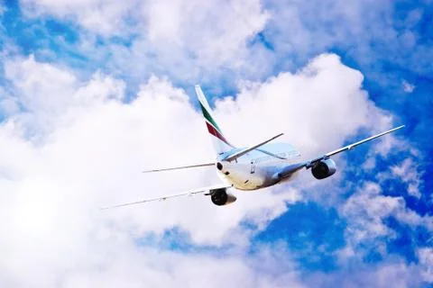 Airplane at fly on the sky with clouds Foto stock