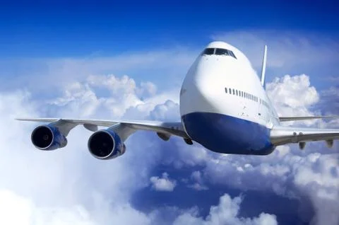 Airplane at fly on the sky with clouds Stock Photos