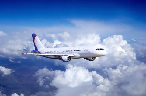 Airplane at fly on the sky with clouds Stock Photos