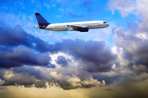 Airplane at fly on the sky with clouds Stock Photos