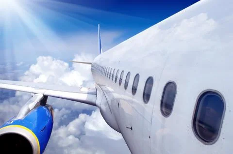Airplane at fly on the sky with clouds 写真素材