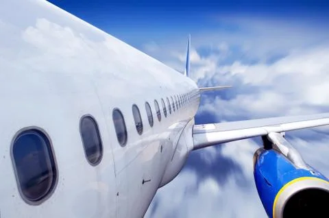 Airplane at fly on the sky with clouds Stock Photos