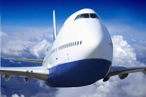 Airplane at fly on the sky with clouds Stock Photos