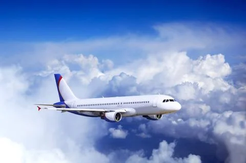 Airplane at fly on the sky with clouds Stock Photos