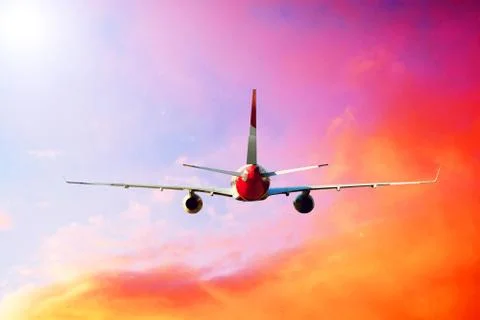 Airplane at fly on the sky with clouds Stock Photos