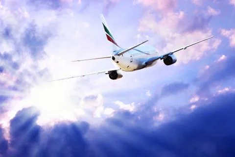 Airplane at fly on the sky with clouds Stock Photos