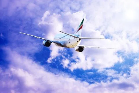 Airplane at fly on the sky with clouds Stock Photos