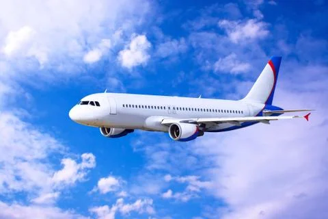 Airplane at fly on the sky with clouds Stock Photos