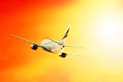 Airplane at fly on the sky with clouds Stock Photos