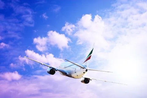 Airplane at fly on the sky with clouds Stock Photos