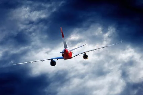 Airplane at fly on the sky with clouds Stock Photos