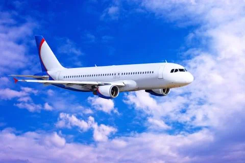 Airplane at fly on the sky with clouds Stock Photos