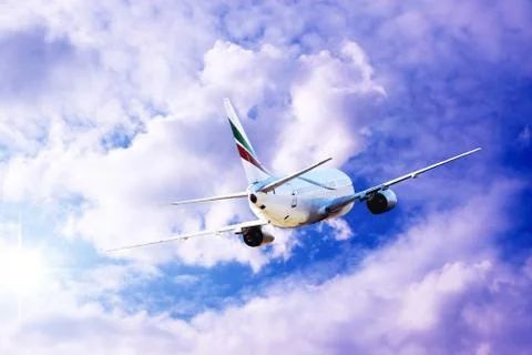 Airplane at fly on the sky with clouds Stock Photos
