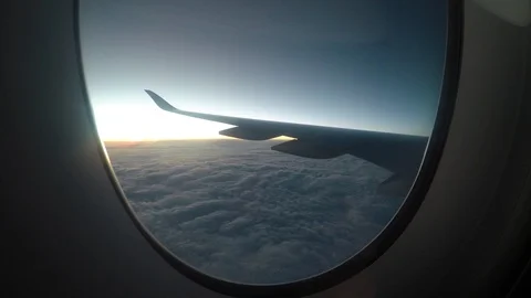 Airplane flying above clouds at sunset. Stock Footage 99847928