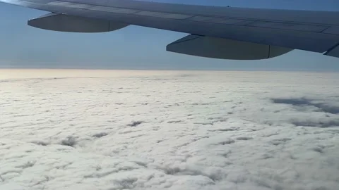 The airplane flying above the clouds. View to the wing of plane. Stock Footage 163317501
