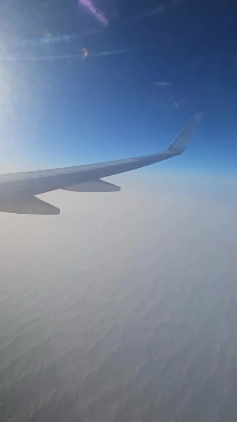 Airplane flying above dense clouds with wavy structure. Jet cruising over thick Stock Footage 329771226