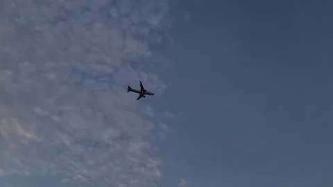 Airplane flying above thick clouds during sunrise Video stock 312241824
