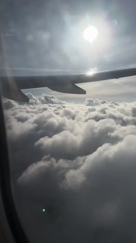 Airplane flying above thick cloudscape with dramatic sky view from window Stock Footage 306959858