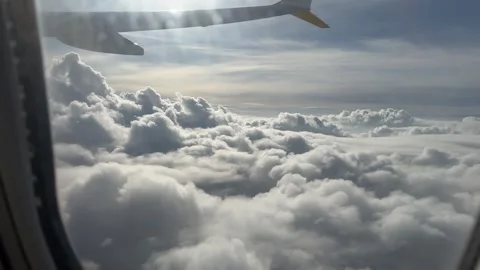 Airplane flying above thick cloudscape with dramatic sky view from window Stock Footage 306959869