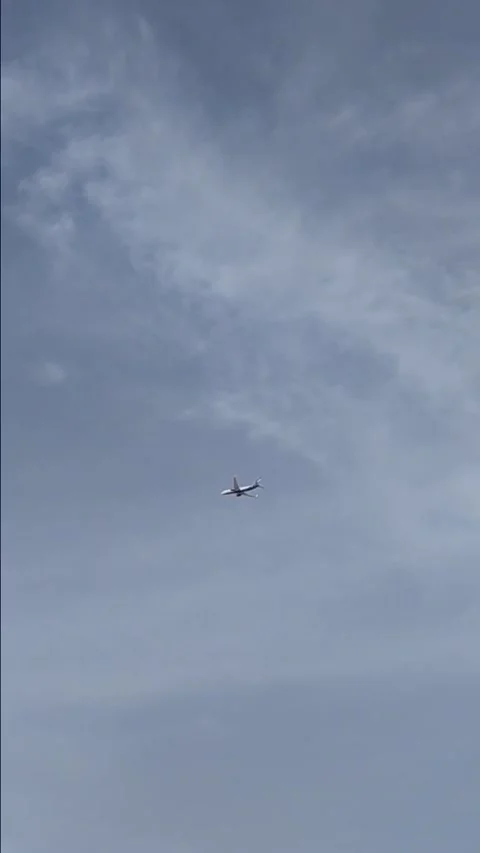 Airplane flying across the clear blue sky Stock Footage 335958855