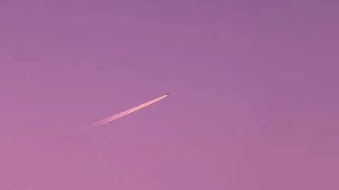 Airplane flying across a magical sunset sky Stock Footage 337451661