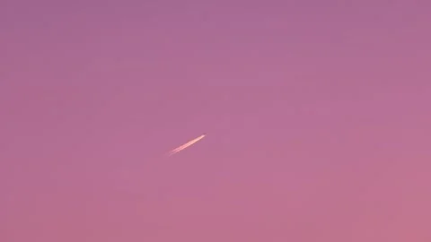 Airplane flying across a magical sunset sky Stock Footage 337451664