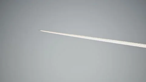 Airplane flying against blue cloudless sky leaving white contrail behind Stock Footage 193069324