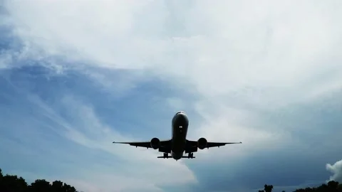 Airplane Flying against Blue Sky. Taking Off. Silhouette of the aircraft landing Stock Footage 144415264