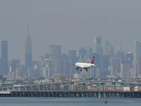 Airplane flying approaching landing in New York City Stock Footage