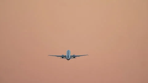 Airplane Flying Away into Sunset Sky Stock Footage 336781598
