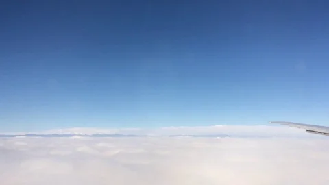 Airplane flying from blue sky to gray clouds Stock Footage 74472170