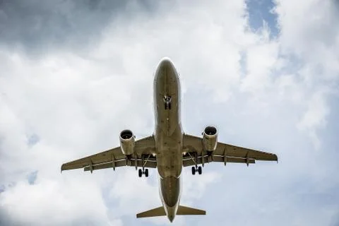 Airplane flying with clouds in background 库存照片