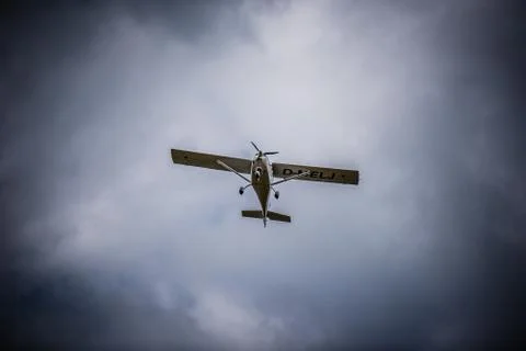 Airplane flying with clouds in background Fotos de archivo