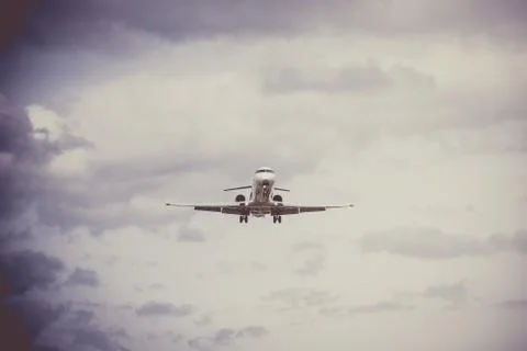 Airplane flying with clouds in background Photos