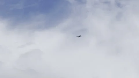Airplane flying in cloudy sky 4K Stock Footage 341833311